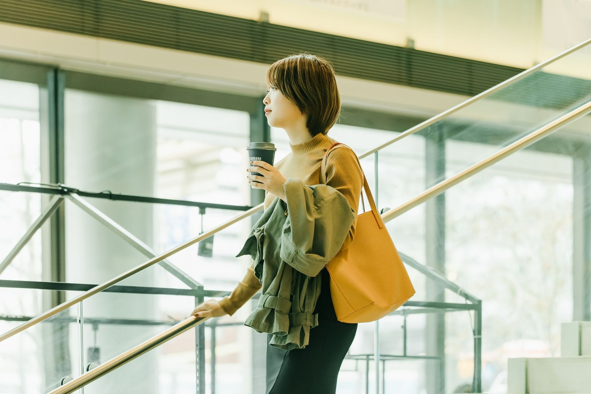 職場でコーヒーを持っている女性