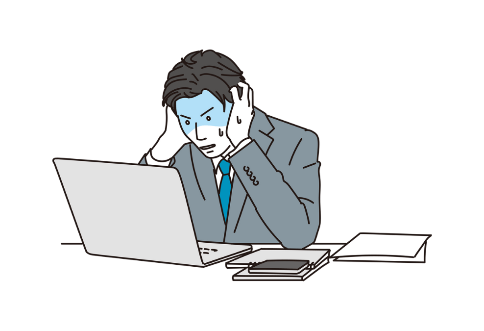 仕事に不安を感じて頭を抱える日本人男性
